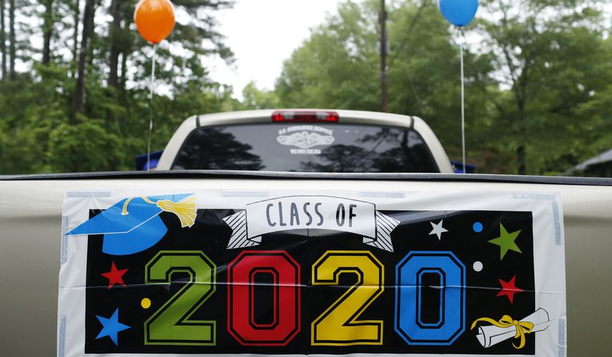 A 2020 banner on the back of a pickup truck before the graduation parade at Cedar Creek neighborhood in Athens, Ga, on Wednesday, May 20, 2020. With all local graduation ceremonies canceled or postponed due to the novel coronavirus pandemic over a dozen cars showed up to take part in the parade. (Joshua L. Jones/Athens Banner-Herald via AP)