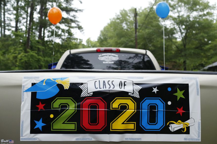 A 2020 banner on the back of a pickup truck before the graduation parade at Cedar Creek neighborhood in Athens, Ga, on Wednesday, May 20, 2020. With all local graduation ceremonies canceled or postponed due to the novel coronavirus pandemic over a dozen cars showed up to take part in the parade. (Joshua L. Jones/Athens Banner-Herald via AP)