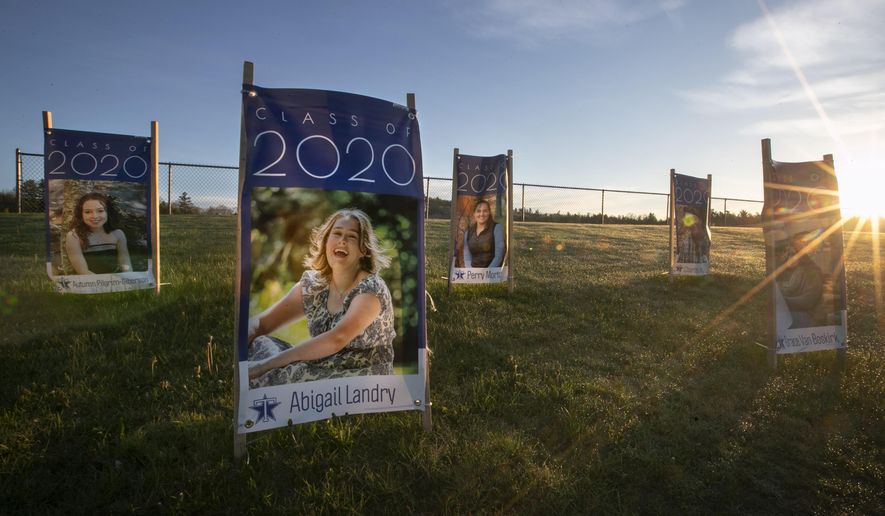 In this Friday, May 22, 2020 photo, portraits of graduating seniors at Telstar Regional High School are displayed near the school's athletic field in Bethel, Maine. Graduation week plans in early June include at town parade and commencement exercise at the Sunday River Ski Resort. (AP Photo/Robert F. Bukaty)
