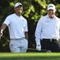 In this April 3, 2018, file photo, Tiger Woods, left, and Phil Mickelson share a laugh on the 11th tee box while playing a practice round for the Masters golf tournament at Augusta National Golf Club in Augusta, Ga. The next match involving Tiger Woods and Phil Mickelson involves a $10 million donation for COVID-19 relief efforts, along with plenty of bragging rights in a star-powered foursome May 24 at Medalist Golf Club. Turner Sports announced more details Thursday, May 7, 2020, for “The Match: Champions for Charity,” a televised match between Woods and Peyton Manning against Mickelson and Tom Brady. (Curtis Compton/Atlanta Journal-Constitution via AP, File)  **FILE**
