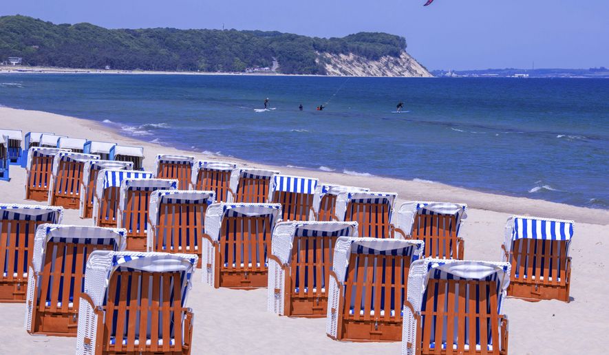Chairs stand with the prescribed safety distance on a beach of G&#x27;hren on the island of R&#x27;gen, Mecklenburg-Western, Germany, Friday, May 22, 2020. After the shutdown as a coronavirus protection measure in mid-March, the tourism industry in Mecklenburg-Western Pomerania is starting again step by step. From May 25, 2020 guests from other federal states will again be allowed to travel to the north-east. (Jens B&#x27;ttner/dpa via AP)