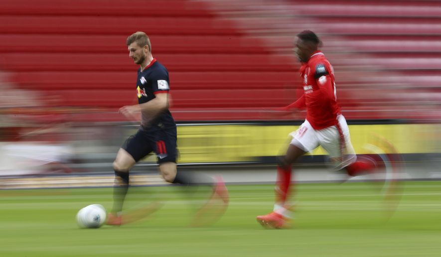 Leipzig's Timo Werner in action with 1.FSV Mainz 05's Moussa Niakhate during a German Bundesliga soccer match between FSV Mainz 05 and RB Leipzig in Mainz, Germany, Sunday, May 24, 2020. (Kai Pfaffenbach/pool via AP)