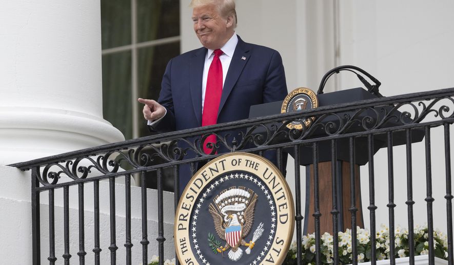 President Donald Trump points during a &amp;quot;Rolling to Remember Ceremony,&amp;quot; to honor the nation&#x27;s veterans and POW/MIA, from the Blue Room Balcony of the White House, Friday, May 22, 2020, in Washington. (AP Photo/Alex Brandon)