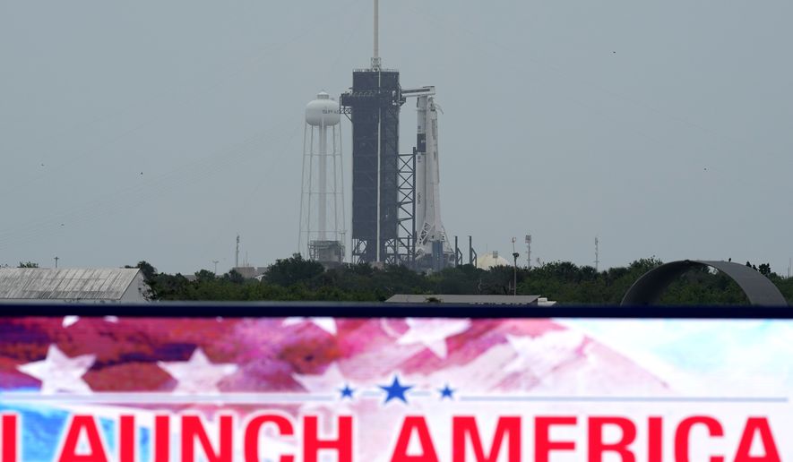 The SpaceX Falcon 9, with the Crew Dragon spacecraft on top of the rocket, sits on Launch Pad 39-A Monday, May 25, 2020, at Kennedy Space Center, Fla. Two astronauts will fly on the SpaceX Demo-2 mission to the International Space Station scheduled for launch on May 27. (AP Photo/David J. Phillip)