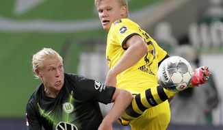 Wolfsburg&#39;s Xaver Schlager, left, vies for the ball with Dortmund&#39;s Erling Haaland during the German Bundesliga soccer match between VfL Wolfsburg and Borussia Dortmund in Wolfsburg, Germany, Saturday, May 23, 2020. The German Bundesliga is the world&#39;s first major soccer league to resume after a two-month suspension because of the coronavirus pandemic. (AP Photo/Michael Sohn, Pool)