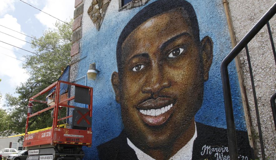 In this May 17, 2020, photo, a recently painted mural of Ahmaud Arbery is on display in Brunswick, Ga., where the 25-year-old man was shot and killed in February. It was painted by Miami artist Marvin Weeks. (AP Photo/Sarah Blake Morgan)