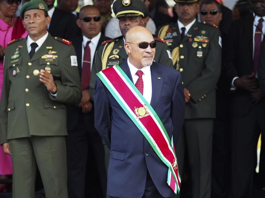 FILE - In this Aug. 12, 2015 file photo, Suriname President Desire &amp;quot;Desi&amp;quot; Delano Bouterse observes a military parade, after being sworn in for his second term, in Paramaribo, Suriname. The president stands a fair chance of holding onto power as the small South American nation elects a new National Assembly on Monday, May 25, 2020, a body that will choose the next president in August. (AP Photo/Ertugrul Kilic, File)