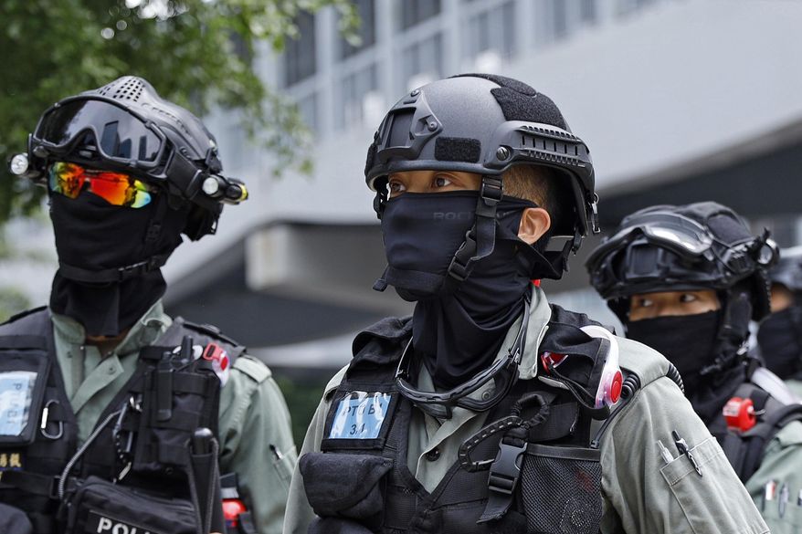 Riot police stand guard outside the Legislative Council building in Hong Kong, Wednesday, May 27, 2020. Hong Kong's legislature begins debate on a bill that would criminalize insulting or abusing the Chinese national anthem. Opponents see the proposal as part of growing central government infringement on freedoms in the semi-autonomous territory. (AP Photo/Kin Cheung)