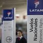 In this July 25, 2016, file photo, an agent of LATAM airlines stands by the counters at the airport in Santiago, Chile. The South American carrier said Tuesday, May 26, 2020, that it is seeking Chapter 11 bankruptcy protection as it grapples with the sharp downturn in air travel sparked by the coronavirus pandemic. (AP Photo/Esteban Felix, File)