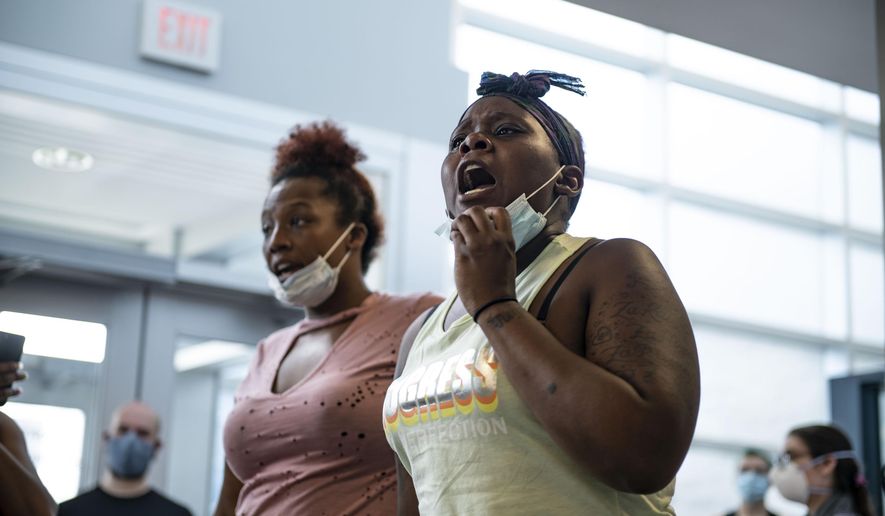 Daughter of Sha' Teina Grady El, Jaquisy Grady speaks up with other protesters Tuesday, May 26, 2020 while gathered inside the Washtenaw County Sheriff's office to await an answer after a deputy was recorded punching her mother in the head multiple times during an arrest at the Washtenaw Sheriff's Office in Ypsilanti, Mich.(Nicole Hester/Ann Arbor News via AP)