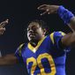 FILE - In this Nov. 17, 2019, file photo, Los Angeles Rams cornerback Jalen Ramsey celebrates the team&#39;s win over the Chicago Bears in an NFL football game in Los Angeles. Ramsey says he won’t hold out as he heads into the final year of his rookie contract and his first full season with the Rams. After a tumultuous tenure in Jacksonville, the star cornerback sounds content in Los Angeles and eager to play new roles on defense. (AP Photo/Kyusung Gong, File)