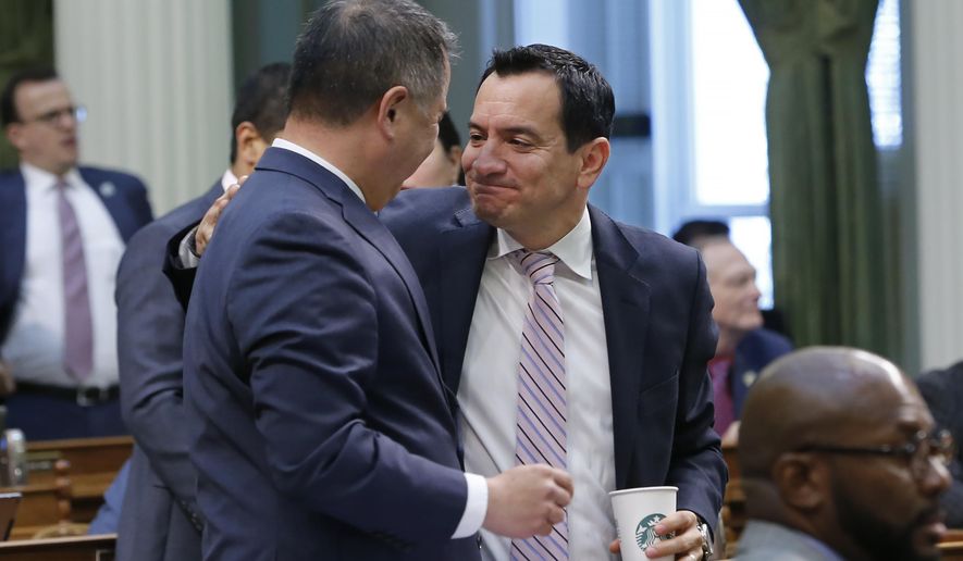 FILE — In this June 13, 2019 file photo, Assemblyman Phil Ting, D-San Francisco, left, chairman of the Assembly Budget Committee is congratulated by Assembly Speaker Anthony Rendon, Lakewood, after the Assembly approved the state budget in Sacramento, Calif. On Tuesday, May 26, 2020 the Assembly will meet as a &amp;quot;Committee of the Whole&amp;quot; to question Gov. Gavin Newsom&#x27;s administration about its plan to fill an estimated $54.3 budget deficit, because of the coronavirus. (AP Photo/Rich Pedroncelli, File)