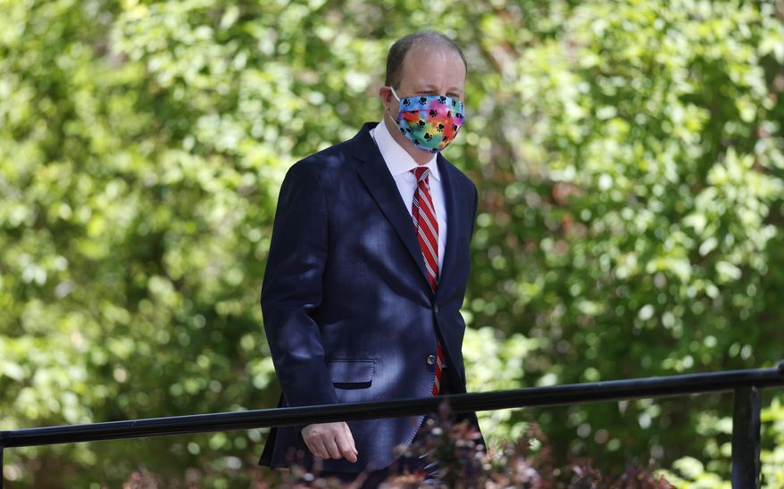Colorado Gov. Jared Polis wears a face mask as he heads into a news conference on the state's efforts against the spread of the new coronavirus Tuesday, May 26, 2020, in Denver. (AP Photo/David Zalubowski)