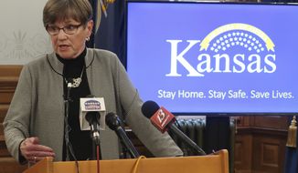 Kansas Gov. Laura Kelly answers reporters&#39; questions about her veto of a sweeping coronavirus bill that would have curbed her power to direct the state&#39;s pandemic response during a news conference, Tuesday, May6 26, 2020, at the Statehouse in Topeka, Kan. The Democratic governor issued a new state of emergency and called the Republican-controlled Legislature into special session to extend that state of emergency. (AP Photo/John Hanna)