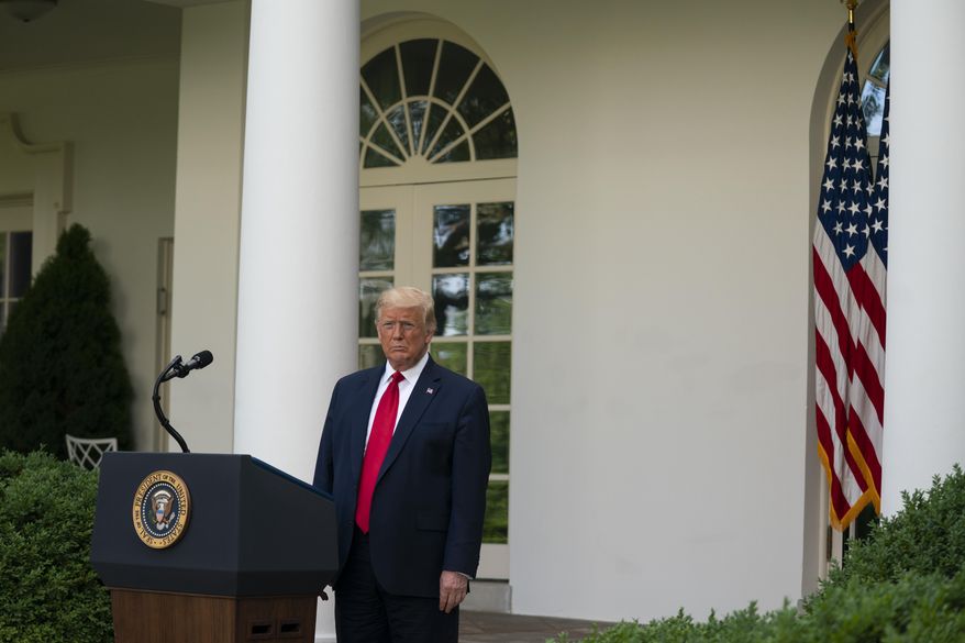 President Donald Trump listens as Vice President Mike Pence speaks during an event on protecting seniors with diabetes in the Rose Garden White House, Tuesday, May 26, 2020, in Washington. (AP Photo/Evan Vucci)