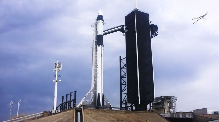 In this image made from video via NASA-TV, a SpaceX Falcon 9, with NASA astronauts Doug Hurley and Bob Behnken in the Dragon crew capsule, prepare to lift off from Pad 39-A at the Kennedy Space Center in Cape Canaveral, Fla., Wednesday, May 27, 2020. The two astronauts are on the SpaceX test flight to the International Space Station. (NASA via AP)