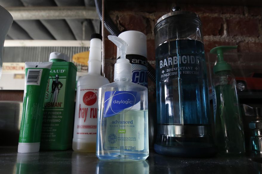 In this file photo, hand sanitizers sit among other items in the East J Barbershop in Sacramento, Calif., Wednesday, May 27, 2020. The New Mexico state Department of Health says there have been three fatalities since May from state residents fatally ingesting hand sanitizer. Three others were hospitalized in critical condition and one person was reportedly permanently blinded. (AP Photo/Rich Pedroncelli) **FILE**