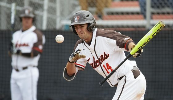 FILE - In this May 10, 2019, file photo, Bowling Green&#39;s Neil Lambert bats during the team&#39;s NCAA college baseball game against Kent Sate in Bowling Green, Ohio. Bowling Green recently announced that it is dropping baseball. Colleges mulling whether to cut sports amid the coronavirus pandemic must ensure they remain compliant with the federal civil-rights law known as Title IX, which requires the equitable treatment of remaining men&#39;s and women&#39;s programs. (AP Photo/Rick Osentoski, File)