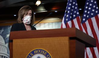 House Speaker Nancy Pelosi of Calif., wears a face mask as she arrives to speaks at a news conference on Capitol Hill in Washington, Thursday, May 28, 2020. (AP Photo/Carolyn Kaster)