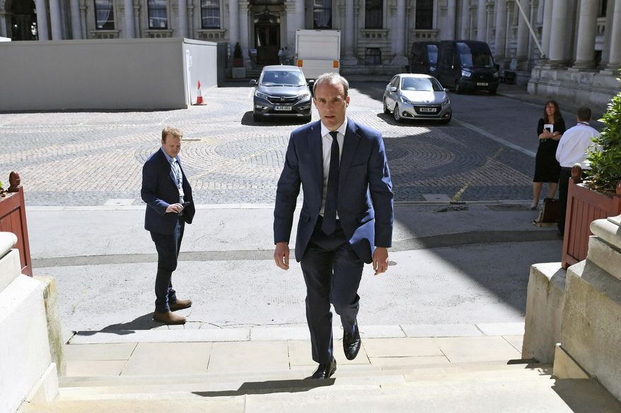 Britain&#39;s Foreign Secretary Dominic Raab arrives at the Foreign and Commonwealth Office in London, Thursday May 28, 2020. Raab has signed a joint statement urging China to work with the government of Hong Kong to find a &amp;quot;mutually acceptable accommodation that will honour China&#39;s international obligations&amp;quot; under the Joint Declaration. (Stefan Rousseau/PA via AP)
