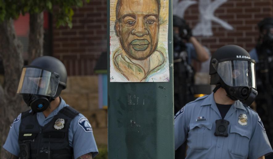 Minnesota police stand outside the department&#39;s 3rd Precinct on Wednesday, May 27, 2020, in Minneapolis. The mayor of Minneapolis called Wednesday for criminal charges against the white police officer seen on video kneeling against the neck of Floyd George, a handcuffed black man who complained that he could not breathe and died in police custody. (Carlos Gonzalez/Star Tribune via AP)
