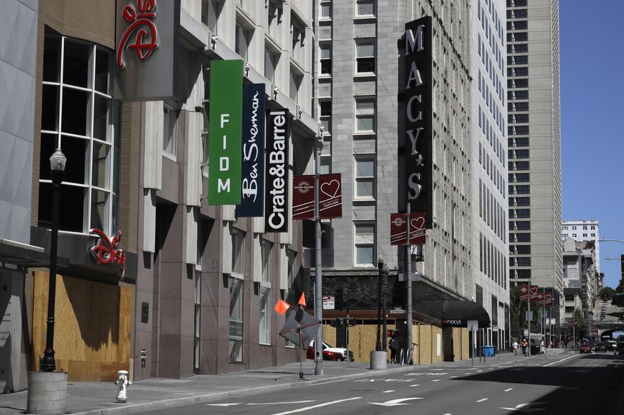 FILE - In this May 27, 2020, file photo, closed businesses are seen in downtown San Francisco. San Francisco will allow outdoor dining and indoor shopping, religious services and even sporting events without spectators June 15 with barbershops and hair salons to open for service in mid July, the city's mayor announced Thursday, May 28, 2020. (AP Photo/Ben Margot, File)
