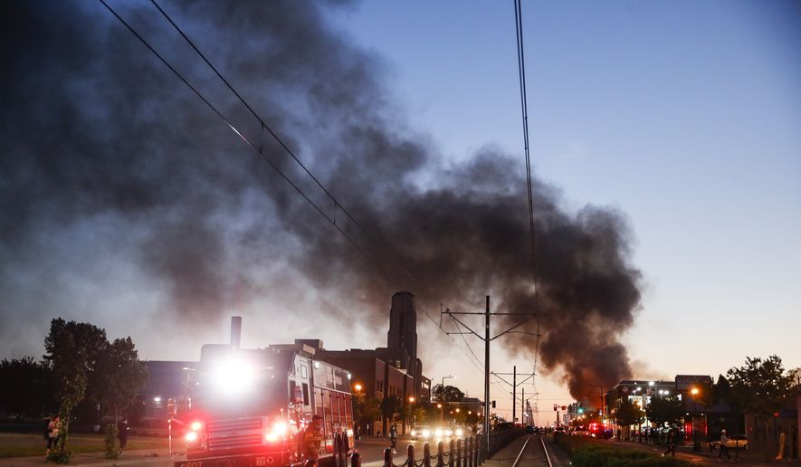 A building burns along University Avenue during a protest, Thursday, May 28, 2020, in St. Paul, Minn. Protests over the death of George Floyd, a black man who died in police custody Monday, broke out in Minneapolis for a third straight night. (AP Photo/John Minchillo)