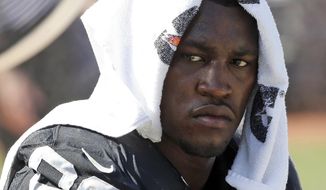 FILE - In this Sept. 20, 2015, file photo, Oakland Raiders&#39; Aldon Smith cools off during an NFL football game against the Baltimore Ravens in Oakland, Calif. Dallas Cowboys defensive end Smith had already been suspended from the NFL several years when his ailing grandmother implored him to change his life before she died of complications from Lou Gehrig&#39;s disease. That conversation, and her death in 2019, were catalysts for Smith trying to get a handle on issues with alcohol, getting in shape and ultimately earning reinstatement nearly five years after he was banished over multiple legal problems. (AP Photo/Tony Avelar, File)