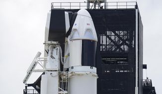 The SpaceX Falcon 9, with Dragon crew capsule on top of the rocket, sits on Launch Pad 39-A, Friday, May 29, 2020, at the Kennedy Space Center in Cape Canaveral, Fla. Two astronauts will fly on the SpaceX Demo-2 mission to the International Space Station scheduled for launch on Saturday, May 30. For the first time in nearly a decade, astronauts will blast into orbit aboard an American rocket from American soil, a first for a private company. (AP Photo/David J. Phillip)