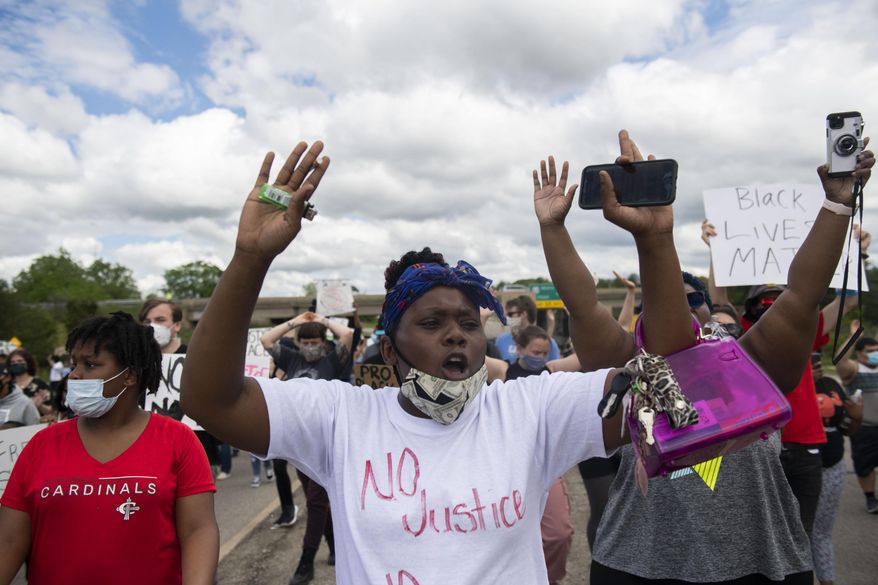 Protesters march in the streets towards U.S. 23 and cross into Ann Arbor, Mich., Thursday, May 28, 2020, during a protest for Sha'Teina Grady El, an Ypsilanti woman who was punched repeatedly in the head by a Washtenaw County Sheriff's deputy last weekend. (Nicole Hester/Ann Arbor News via AP)