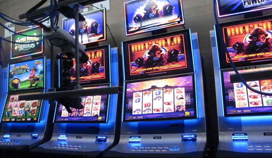 FILE - This Feb. 10, 2020, file photo shows slot machines at the Hard Rock casino in Atlantic City,N.J., that are controlled by gamblers over the internet. The coronavirus pandemic could lead to a quicker expansion of sports betting and internet gambling in the U.S. as states deal with huge budget deficits and look for new tax revenue wherever they can find it. (AP Photo/Wayne Parry, FIle)