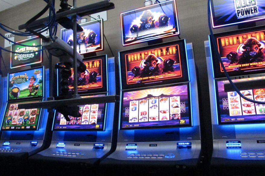 FILE - This Feb. 10, 2020, file photo shows slot machines at the Hard Rock casino in Atlantic City,N.J., that are controlled by gamblers over the internet. The coronavirus pandemic could lead to a quicker expansion of sports betting and internet gambling in the U.S. as states deal with huge budget deficits and look for new tax revenue wherever they can find it. (AP Photo/Wayne Parry, FIle)