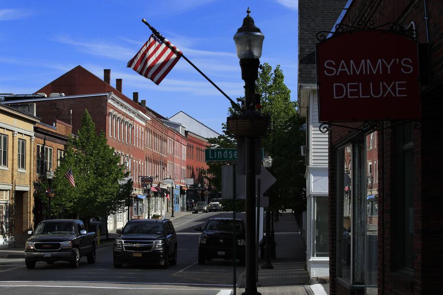 In this Thursday, May 28, 2020 photo, automobiles travel on Main Street in Rockland, Maine. The city had proposed shutting down Main Street for the entire month of June to cater to shoppers and diners but concerns from business owners caused officials to scale back the plan. The new plan calls for shutting down the street on just the last two weekends in June. (AP Photo/Robert F. Bukaty)