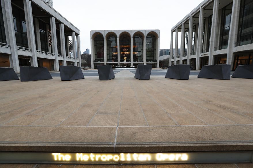Josie Robertson Plaza at Lincoln Center is nearly deserted Thursday, March 12, 2020, in New York, after nearly all of Lincoln Center's performance spaces shuttered their doors following a statewide ban on gatherings of more than 500 people. New York Gov. Andrew Cuomo imposed the temporary ban amid a rise in coronavirus cases. (AP Photo/Kathy Willens)