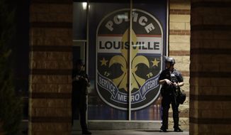 Louisville Police Department officers stand outside during a protest over the deaths of George Floyd and Breonna Taylor, Saturday, May 30, 2020, in Louisville, Ky. Breonna Taylor, a black woman, was fatally shot by police in her home in March. (AP Photo/Darron Cummings)