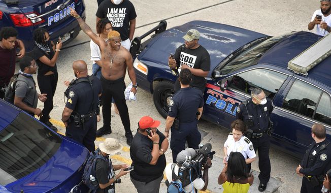 Atlanta Police Chief Erika Shields speaks with media as protesters gather, Friday, May 29, 2020, in Atlanta, in response to the death of George Floyd in police custody on Memorial Day in Minneapolis. (AP Photo/Mike Stewart)