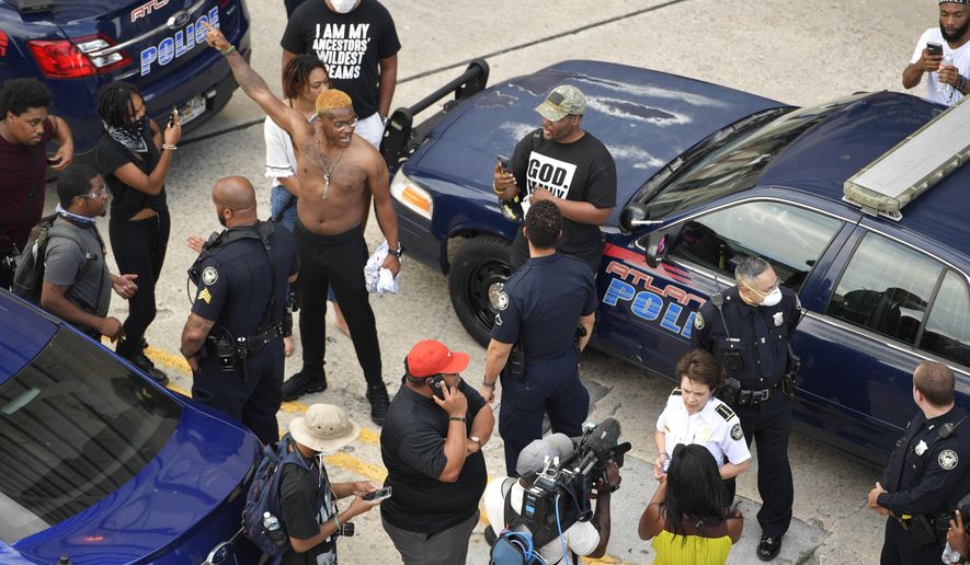 Atlanta Police Chief Erika Shields speaks with media as protesters gather, Friday, May 29, 2020, in Atlanta, in response to the death of George Floyd in police custody on Memorial Day in Minneapolis. (AP Photo/Mike Stewart)