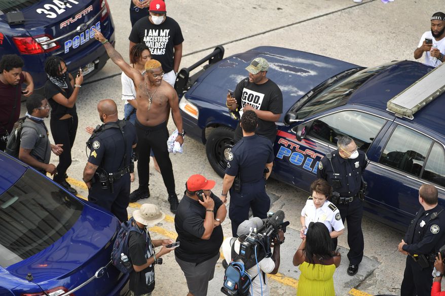 Atlanta Police Chief Erika Shields speaks with media as protesters gather, Friday, May 29, 2020, in Atlanta, in response to the death of George Floyd in police custody on Memorial Day in Minneapolis. (AP Photo/Mike Stewart)