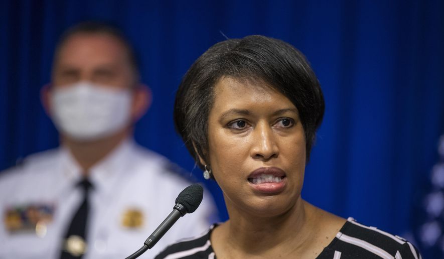 District of Columbia Mayor Muriel Bowser with Metropolitan Police Department Chief Peter Newsham, speaks to reporters during a news conference in Washington on Saturday, May 30, 2020. (AP Photo/Manuel Balce Ceneta) **FILE**