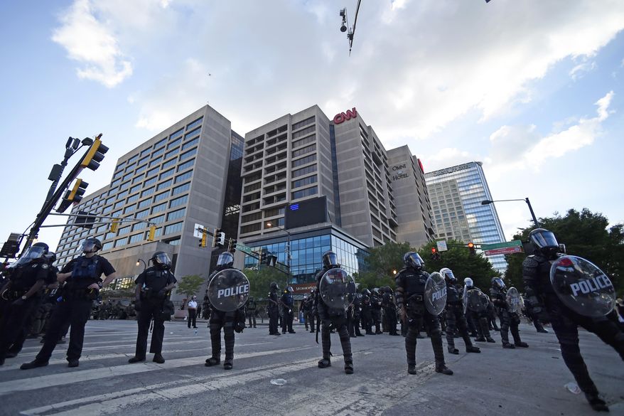 Atlanta Police, monitor demonstrators protesting, Saturday, May 30, 2020 in Atlanta. The protest started peacefully earlier in the day before demonstrators clashed with police. (AP Photo/Mike Stewart)