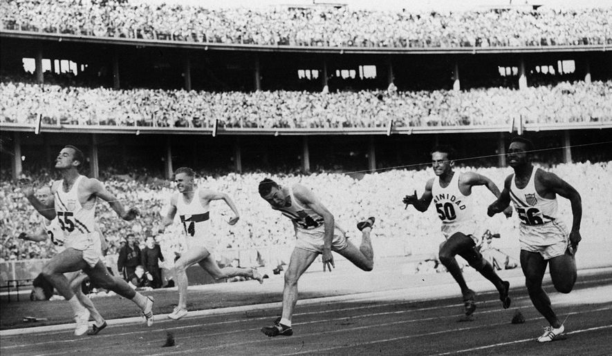 FILE - In this Nov. 23, 1956, file photo, United States&#39; Bobby Joe Morrow (55) crosses the finish line of the men&#39;s 100-meter race in 10.5 seconds, equaling an Olympic record, during the Summer Olympics in Melbourne, Australia. Morrow, the Texas sprinter who won three gold medals in the 1956 Melbourne Olympics while a student at Abilene Christian University, died Saturday, May 30, 2020. He was 84. (AP Photo/File)