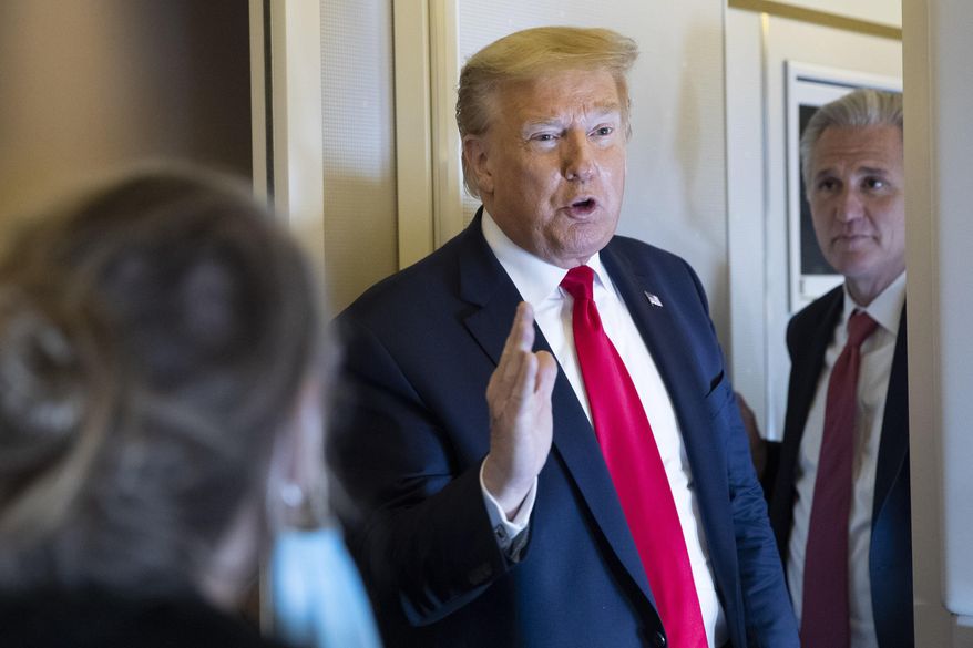 Former President Donald Trump, with House Minority Leader Kevin McCarthy of Calif., speaks with reporters en route to Andrews Air Force Base Saturday, May 30, 2020, in flight. (AP Photo/Alex Brandon)