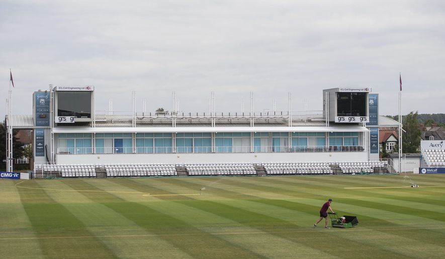 Head groundsman Craig Harvey tends to the outfield at the County Ground, home of Northamptonshire County Cricket Club, in Northampton, England, Wednesday May 27, 2020. Professional cricket teams are waiting to be given the green light to return to competitive sport following the highly contagious coronavirus pandemic. (Joe Giddens / PA via AP)
