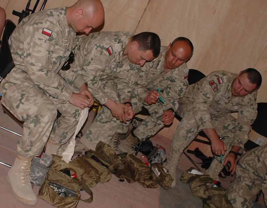 Polish medics train using Unites States Army Combat Lifesaver bags during a training course May 5, at Forward Operating Base Salerno. To prepare them for conducting joint operations with U.S. forces, the medics are being given a CLS class to familiarize them with U.S. military medical procedures, as well as to give them their last refresher course before they go out on missions. "This course is very good, because of how realistic it is," said Polish Major Mark Pierkarski, a field surgeon. Once the medics move to their FOBs and firebases, they will work jointly with U.S. medics in aid stations. (U.S. Army photo/Pfc. Micah E. Clare)
