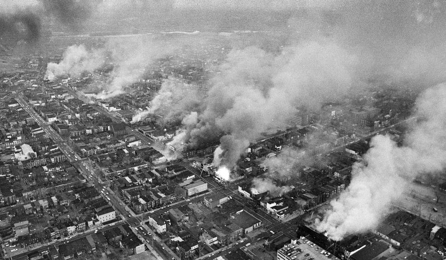 FILE - In this April 5, 1968 file photo, buildings burn along H Street in the northeast section of Washington, set afire during a day of demonstrations and rioting in reaction to the assassination of Dr. Martin Luther King Jr. (AP Photo/Charles Gorry, File)
