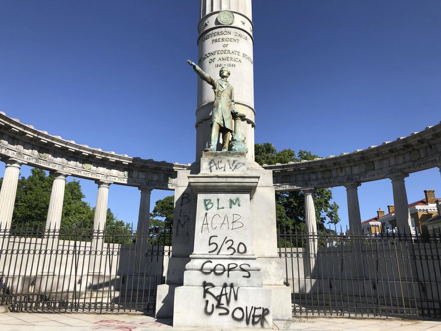 A monument to Confederate President Jefferson Davis in Richmond, Va., is covered with graffiti on Sunday, May 31, 2020, after overnight protests over the death of George Floyd. Many of the city’s most prominent Confederate monuments were tagged with similar graffiti. Protests were held in U.S. cities over the death of Floyd, a black man who died after being restrained by Minneapolis police officers on May 25. (AP Photo/ Sarah Rankin)