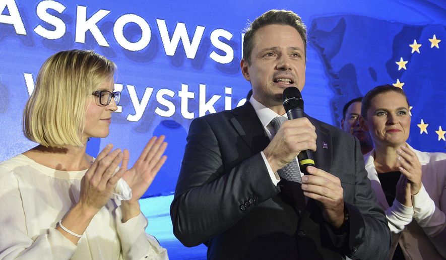 FILE - In this Sunday, Oct. 21, 2018 file photo Warsaw city mayor candidate from the main opposition party Civic Platform, Rafal Trzaskowski speaks to supporters after first exit polls indicating him as the winner are announced in Warsaw, Poland. Trzaskowski, a pro-European Union liberal, has recently joined the race for the nation's president and has emerged as the main challenger to incumbent President Andrzej Duda who had previously seemed certain to win. The date of the vote is yet to be announced. (AP Photo/Alik Keplicz, File)