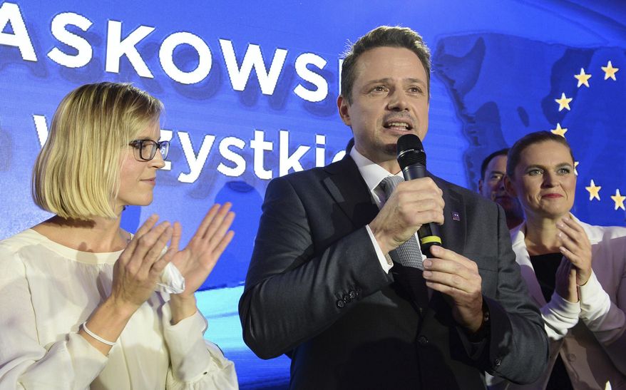 FILE - In this Sunday, Oct. 21, 2018 file photo Warsaw city mayor candidate from the main opposition party Civic Platform, Rafal Trzaskowski speaks to supporters after first exit polls indicating him as the winner are announced in Warsaw, Poland. Trzaskowski, a pro-European Union liberal, has recently joined the race for the nation's president and has emerged as the main challenger to incumbent President Andrzej Duda who had previously seemed certain to win. The date of the vote is yet to be announced. (AP Photo/Alik Keplicz, File)