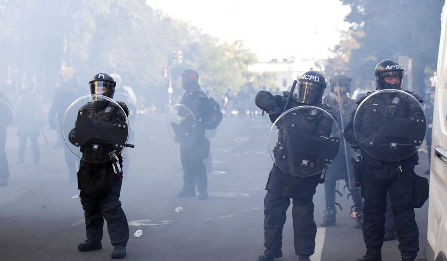 Police clear demonstrators from Lafayette Park as they protest the death of George Floyd, Monday, June 1, 2020, in Washington. Floyd died after being restrained by Minneapolis police officers. (AP Photo/Alex Brandon)