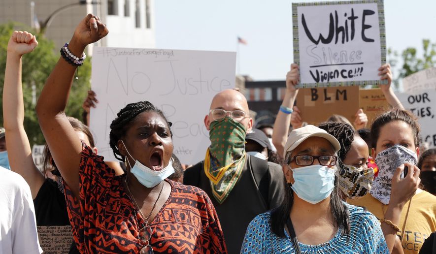 Protesters chant as they march in the street way from the City Justice Center Monday, June 1, 2020, in St. Louis. Protesters gathered to speak out against the death of George Floyd who died after being restrained by Minneapolis police officers on May 25. (AP Photo/Jeff Roberson)